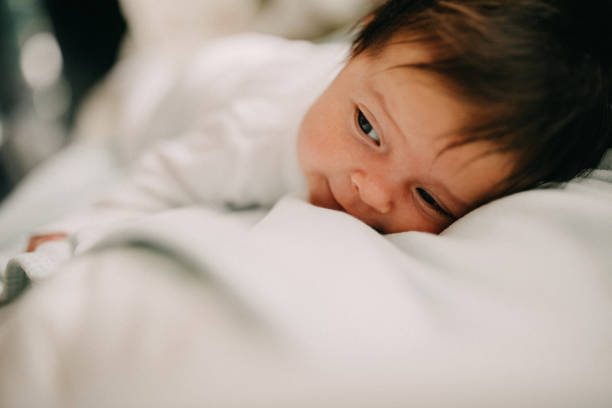 istock New born laying on bed 1080490624
