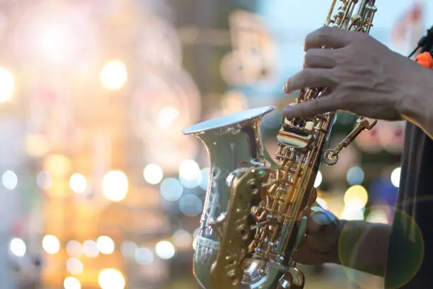 Photo of International jazz day and World Jazz festival. Saxophone, music instrument played by saxophonist player musician in fest.