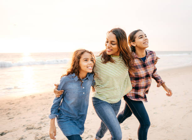 istock Mother with two daughters on the beach 1080494346