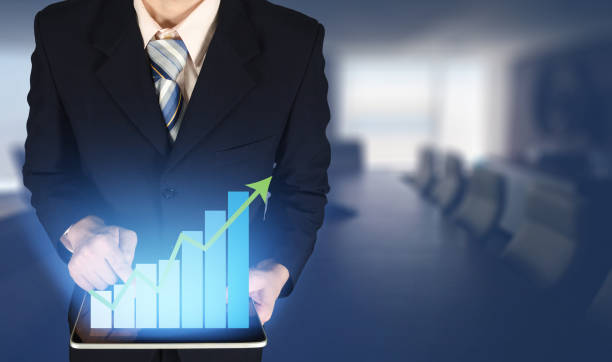 istock Double exposure businessman touching growth bar chart on financial graph, blurred meeting room background. 1080496206