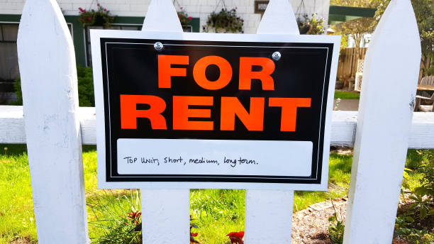 istock FOR RENT Sign On White Picket Fence 1080498272