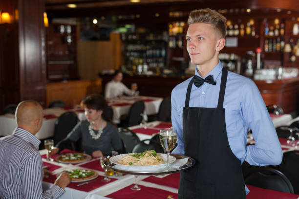 istock Waiter with tray in restaurant 1080498742
