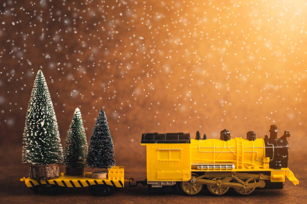 istock christmas eve ideas concept with yellow train is loading big christmas tree with brwon leather background and free copyspace for your ideas text 1080500042