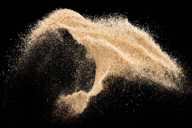 istock Sand flying explosion isolated on black background ,throwing freeze stop motion object design 1080519098