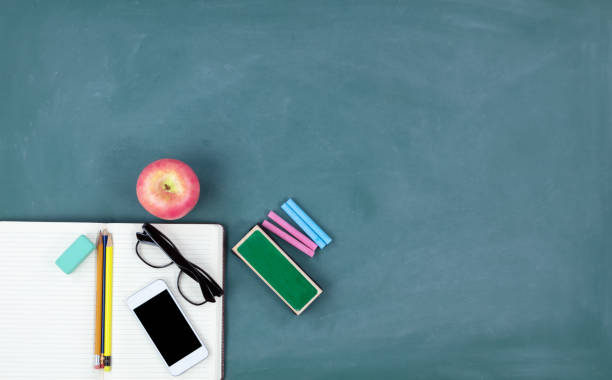 istock Back to school concept with basic stationery on a green chalkboard background 1080539420