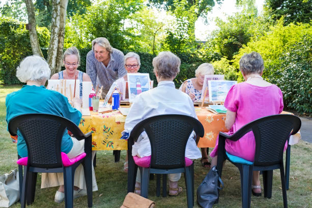 istock Instructor helping a group of ladies at art class. 1080547550