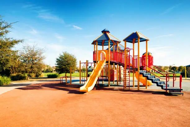 Photo of New Public Suburban Children park playground in California with slides on a sunny day