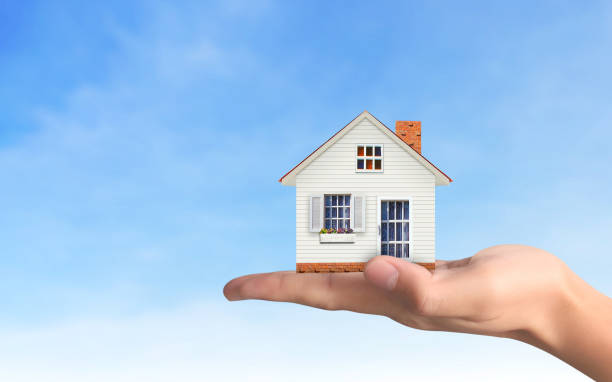 istock Mortgage concept by house from  hand 1080558856