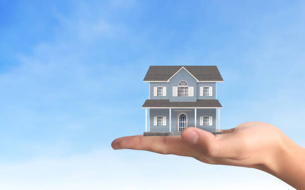 istock Mortgage concept by house from  hand 1080558866