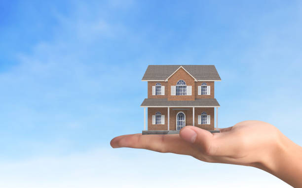 istock Mortgage concept by house from  hand 1080558882