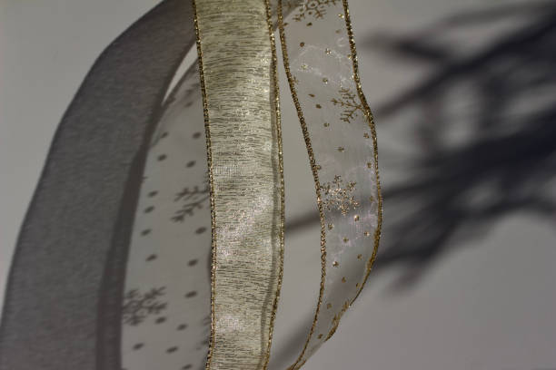 istock Macro gold colored Christmas fabric ribbon abstract background 1080567004