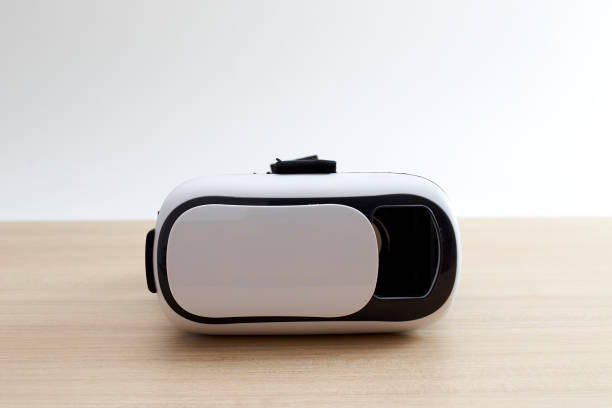istock Virtual reality glasses helmet headset on wooden background. Future technology concept. 1080575444
