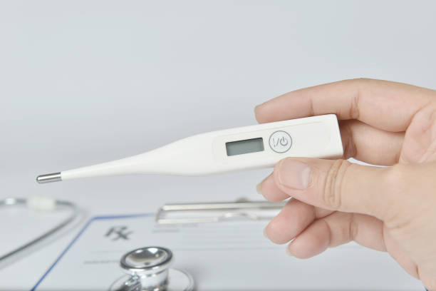 istock Close up of a hand holding a digital thermometer. 1080581862