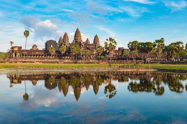 istock Angkor Wat sunny day blue sky main facade reflection on water pond sunset light. World famous temple in Cambodia, tourist travel destination. 1080586012