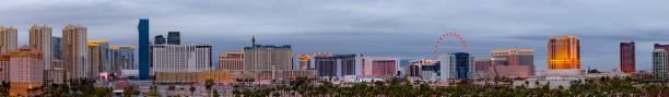Las Vegas Cityscape Panorama on the strip in the evening hour Evening shot of Las Vegas hotels and casinos with palm trees in the foreground wynn las vegas stock pictures, royalty-free photos & images