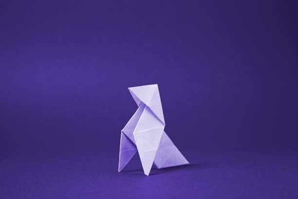 istock Origami paper bird on a red background 1080589680