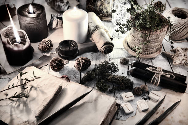 istock Still life with black and white candles, runes, cones and open diary book on table 1080597384