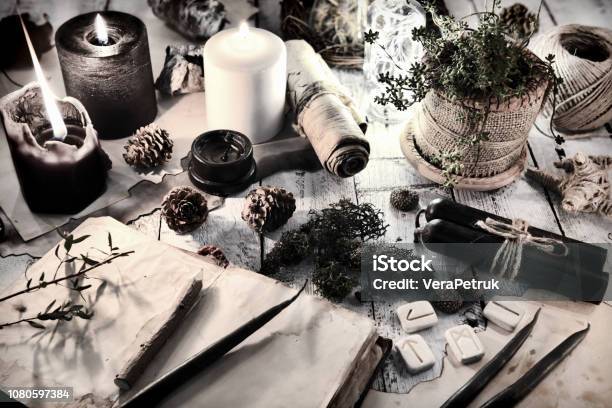 Still Life With Black And White Candles Runes Cones And Open Diary Book On Table Stock Photo - Download Image Now