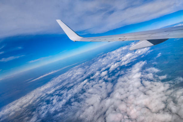 istock Clouds Aerial View with wing of airplane 1080606500