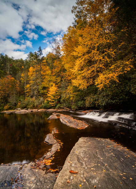istock colorful fall foliage forest and river landscape with a small waterfall 1080614986