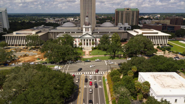 Flags Blow Atop Traffic Below The Capital Dome in Tallahassee Florida The capital city of Tallahassee Florida holds the government office building shown here tallahassee stock pictures, royalty-free photos & images