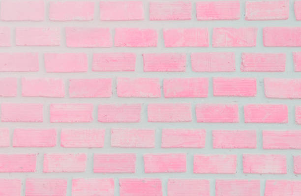 istock Wall stained old grungy stucco texture background. Brickwork flooring interior rock old pattern clean concrete have grid uneven design stack. Abstract kitchen wallpaper modern pink brick tile. 1080620066