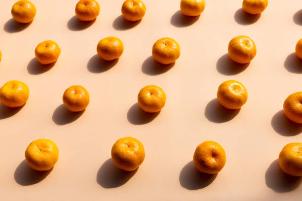 istock top view pattern Background of whole oranges with strong shadow on orange background 1080623620