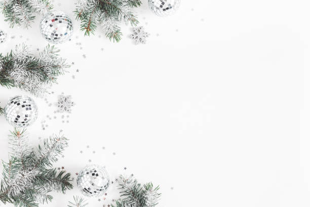 istock Christmas composition. Frame made of fir tree branches, silver decorations on white background. Christmas, winter, new year concept. Flat lay, top view, copy space 1080639646