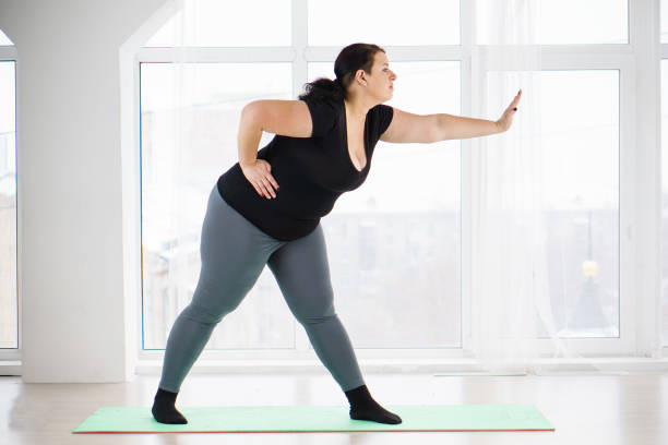 istock overweight woman doing stretching exercises 1080647088
