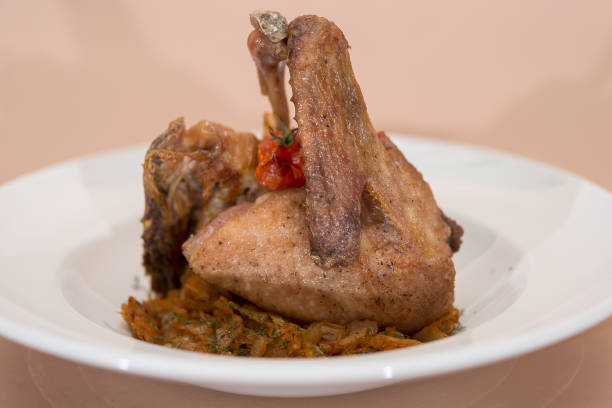 istock Traditional dish with baked drumstick duck and sour cabbage,  decorated with herbs 1080650394