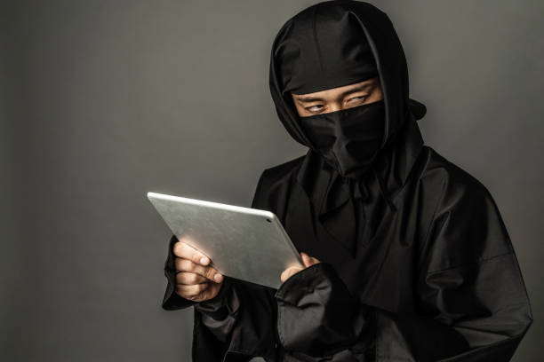 japanese ninja using a tablet pc. - ninja imagens e fotografias de stock