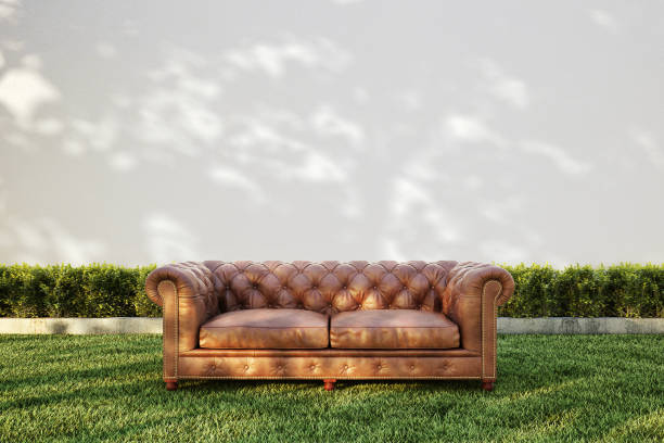 Old worn out 70's style orange sofa lingers on Soho NYC sidewalk just waiting for a drunken rock star to vomit on it.  Includes clipping path.