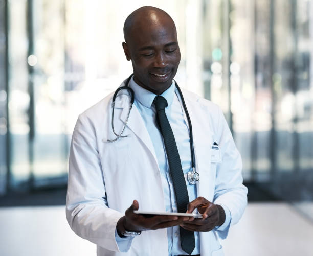 istock Using his tablet to look through medical records 1080663914