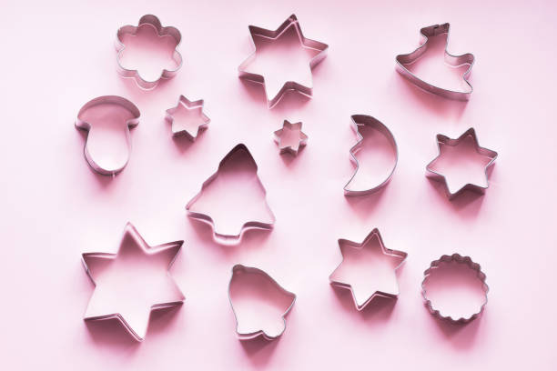 istock Various Christmas-themed cookie cutters on pink. Holiday card. View from above. Xmas pattern. 1080664146