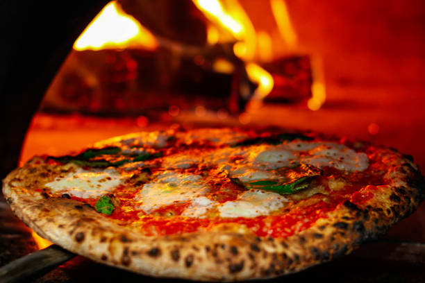 istock Hot big pepperoni pizza. Tasty pizza composition with melting cheese bacon tomatoes ham paprika steam smoke 1080679704