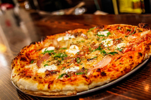 istock Hot big pepperoni pizza. Tasty pizza composition with melting cheese bacon tomatoes ham paprika steam smoke 1080685780