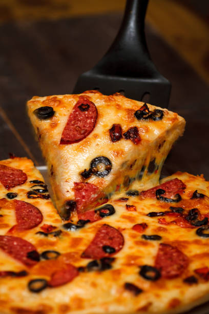 istock Hot big pepperoni pizza. Tasty pizza composition with melting cheese bacon tomatoes ham paprika steam smoke 1080688414