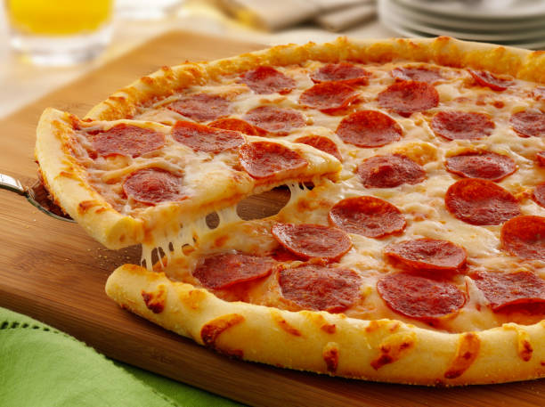 istock Hot big pepperoni pizza. Tasty pizza composition with melting cheese bacon tomatoes ham paprika steam smoke 1080690802