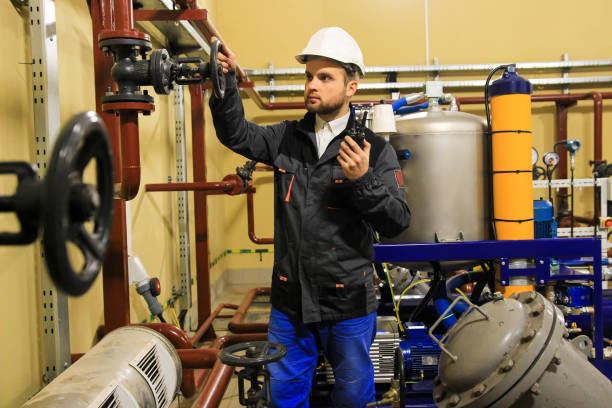 istock Technician engineer opens gate valve of pipeline on oil refinery 1080695818