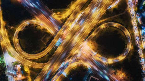 istock Aerial top view highway road intersection roundabout or circle at night for transportation, distribution or traffic background. 1080696132