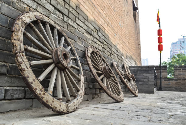 Ancient wooden wheels, standing in a row against the background of ancient brickwork, Xian City, China