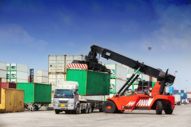 istock Forklift truck working in container warehouse with beautiful sky for logistics shipping, import export or transportation. 1080700220