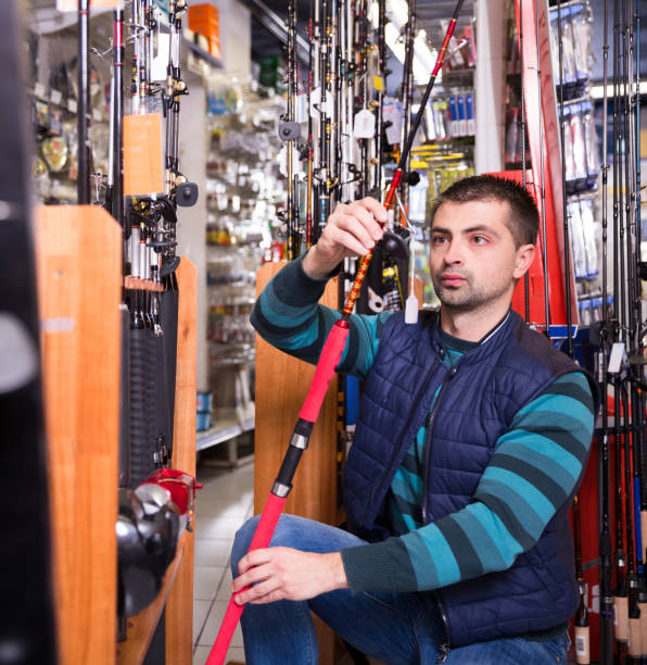istock male  selecting fishing rod 1080700286