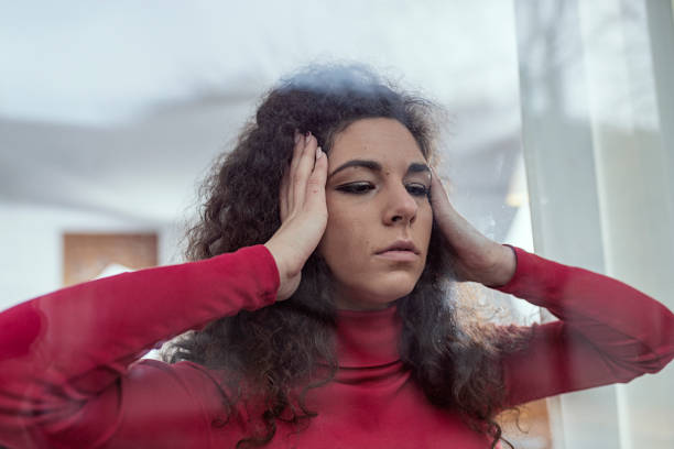 istock Sad Woman Looking Through the Window 1080701614