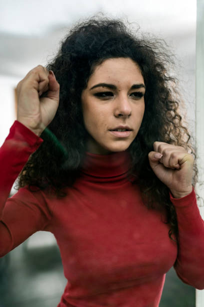 istock Sad Woman Looking Through the Window 1080702822