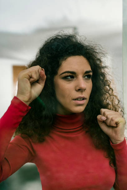 istock Sad Woman Looking Through the Window 1080702942