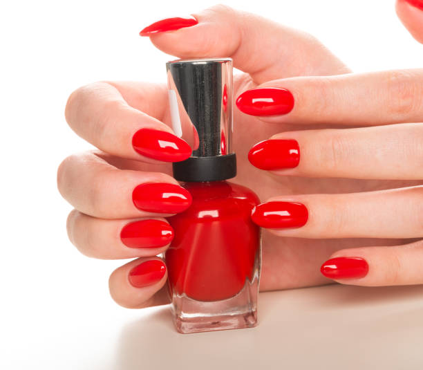 istock Hand with red nail polish bottle 1080703352