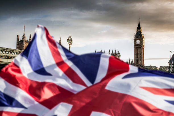 brexit concept - double exposure of flag and Westminster Palace with Big Ben stock photo
