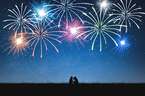 Silhouette of girls selfie on mountain and night sky with fireworks.