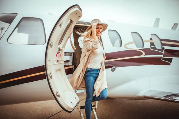 istock Young elegant rich woman exiting a private jet parked on a runway 1080719130